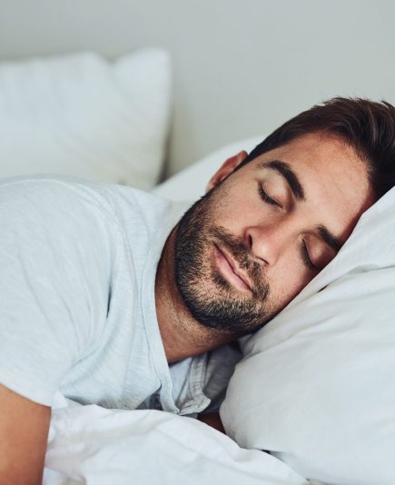 Shot of a tired young man sleeping comfortably in his bed without a sign of being disturbed